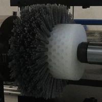 making roller brush with abrasive filaments