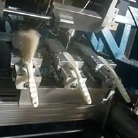 5-axis 3-head machine making small cleaning brushes